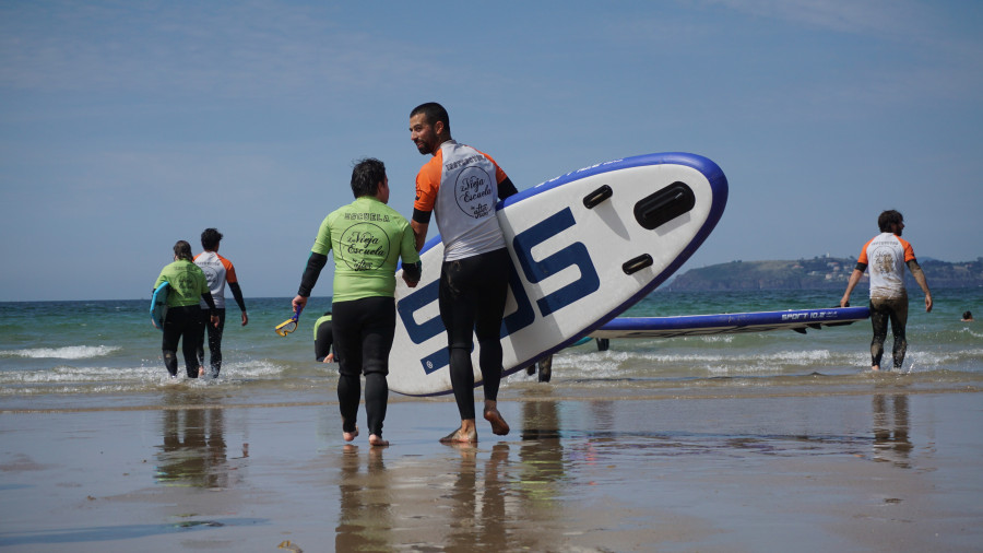 Una tabla de surf y las olas de Bastiagueiro por la inclusión